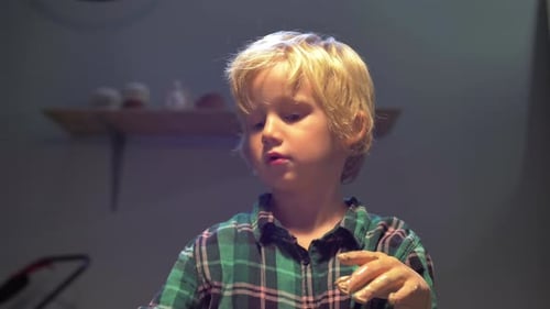 Boy Talks To Woman While Sculpting in the Workshop