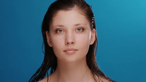 Pretty Cute Girl with Fresh Clean Face and Wet Hair Playing with Eyes and Smiling