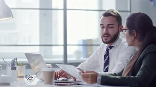 Colleagues Working on Laptop in Office
