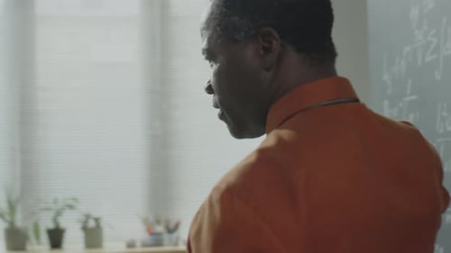 Teacher Explains Math Concepts in Classroom Setting