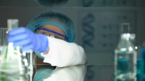 Scientist Analyzing Flask in Medical Research Lab