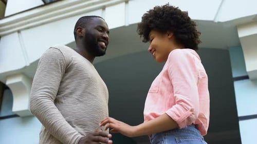 Couple Embrace After a High Five Outdoors