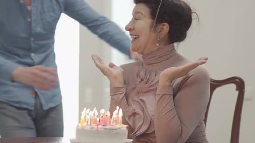 Woman Celebrates Birthday with Young Adult Friend Indoors