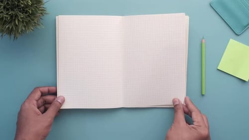 Top View of Man's Hand Turning a Pager of a Diary