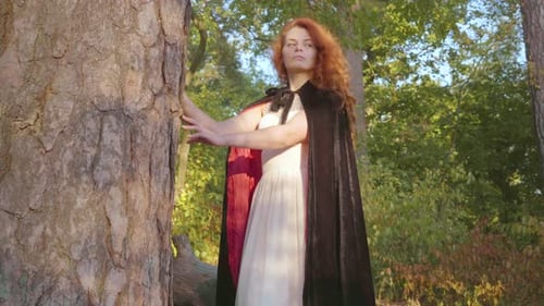 Woman With Red Hair Posing in Forest