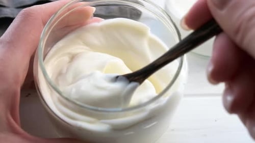 Eat yogurt in glass jar. Healthy breakfast concept