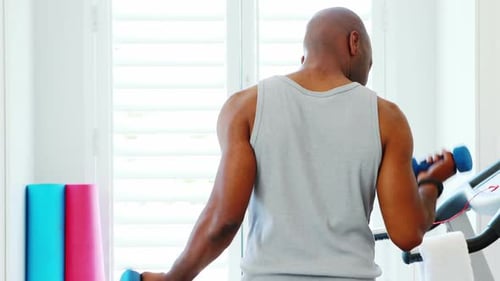 Adult Does Bicep Curls with Dumbbells in Home