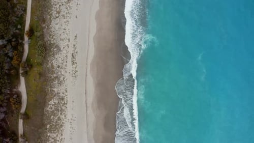 Aerial view sandy beach with white waves