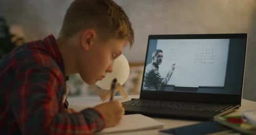 Boy Engaged in Online Tutoring Session at Home