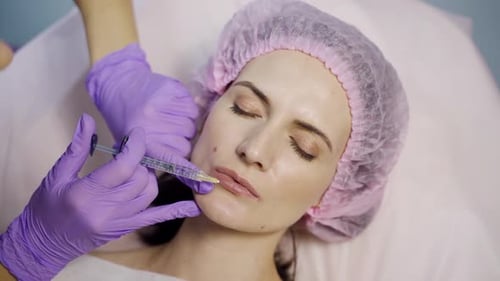 Woman Getting Lip Filler Injection Close Up
