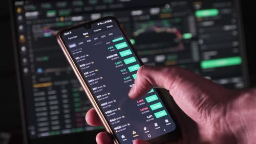 Person Trading Cryptocurrency on Mobile Phone App