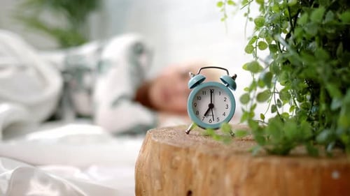 Pretty Young Blonde Woman with Short Haircut Wakes Up in Bed at Home or in Hotel in Morning and