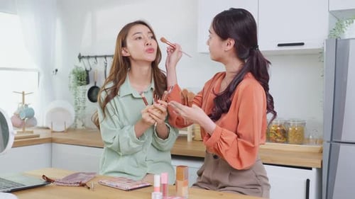 Two Women Filming Makeup Tutorial in Kitchen
