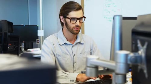 Man Working at Computer in Bright Modern Office