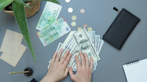 Hands passing hundred dollar bills