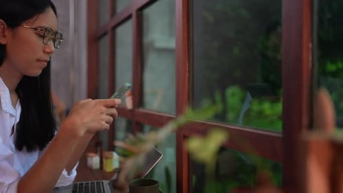 Young Woman Using Phone Indoors