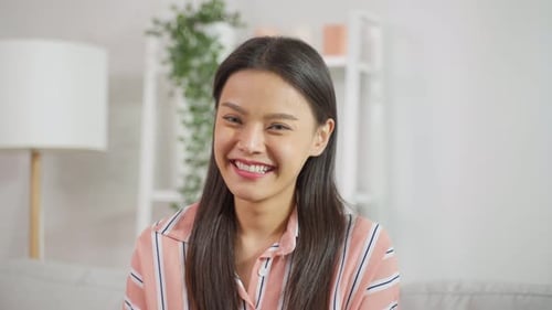 Smiling Woman Looking at Camera Indoors