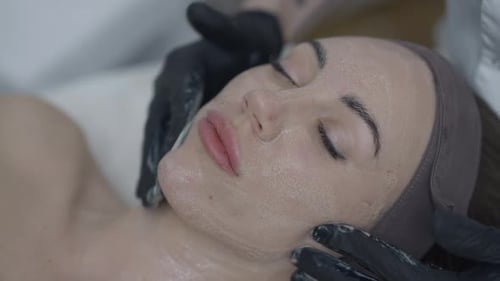 Woman Receiving Facial Massage in Bright Studio