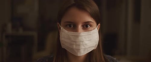 Woman Wearing Face Mask Staring at Camera