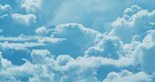 Fluffy Clouds Moving Gently Across a Blue Sky