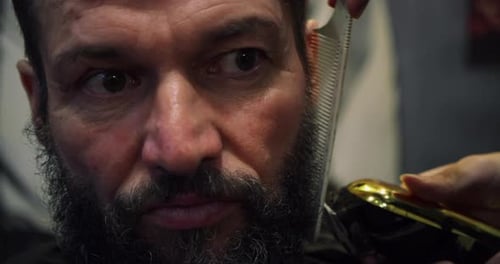 Man Getting Beard Trimmed at Barber Shop