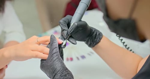 Manicurist Removes Gel Polish with a Cutter From a Girl’s Nails