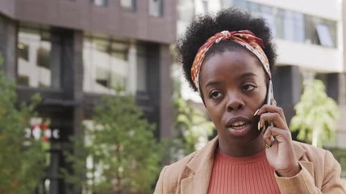 Woman Talking on Phone While Walking in City