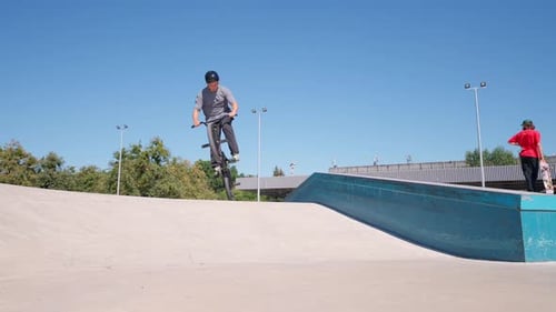 Young Adult Bike Trick in Skatepark on Sunny Day