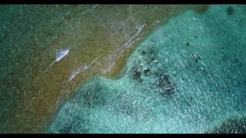 Aerial seascape of tranquil coastline beach holiday by shallow ocean and white sandy background of a