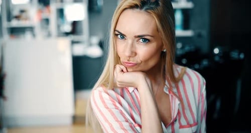 Smiling Blonde Woman Posing Indoors