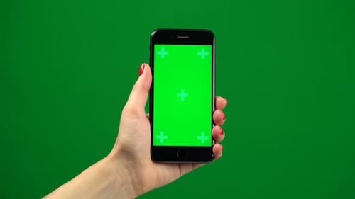 Female Hand Holding the Newest Smartphone on Green Screen