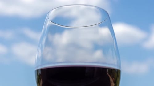 Glass of Red Wine Against Blue Sky