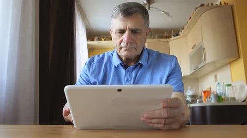 Adult using Tablet Computer at Home