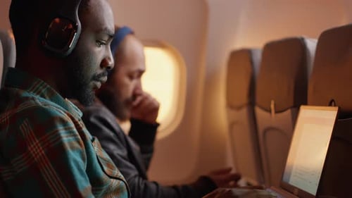 Travelers on an Airplane Using Technology