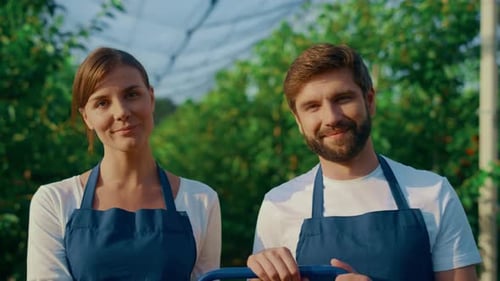 Smiling Man and Woman in Greenhouse