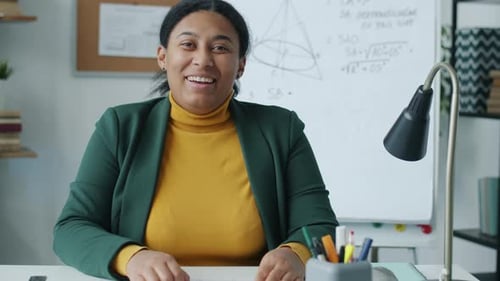 University Teacher Giving Online Lecture on Maths Showing Visual Aid and Speaking Looking at Camera