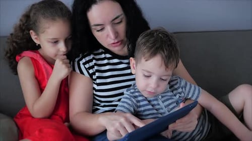 Family Time: Mother and Children with Tablet