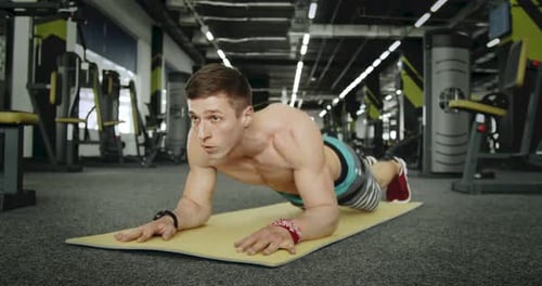 Shirtless Man Doing Pushups at the Gym