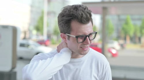 Young Adult Massaging Neck Due To Pain