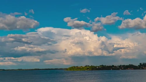 Scenic Clouds Over Tranquil Water Landscape
