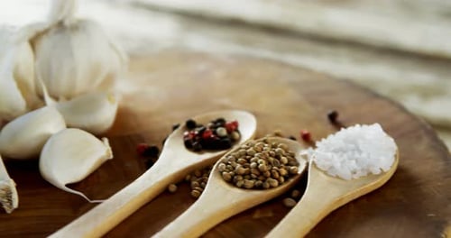Garlic, Salt and Pepper Spice on Wooden Board