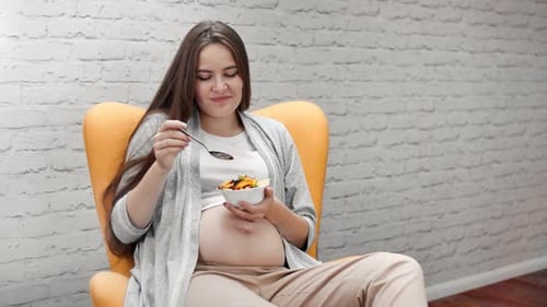 Pregnant Woman Eating Healthy Salad Indoors