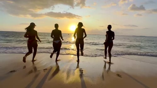 Four Girls Running and Skipping on the Beach Together in Slow Motion Happy Girls on Vacation at the