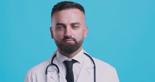Serious Doctor Portrait with Stethoscope and Dark Hair