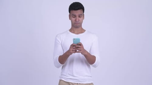Man Using Smartphone With Changing Expressions Indoors