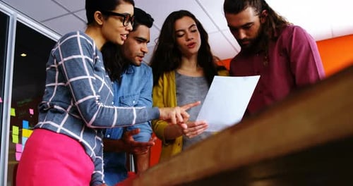Diverse Team Collaborating on Project in Office
