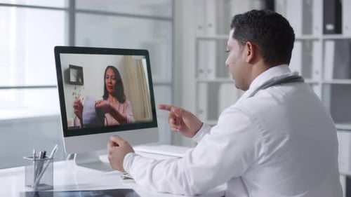 Doctor Consults with Patient During Telehealth Appointment