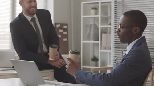 Male Financial Accountants Chatting during Coffee Break in Office
