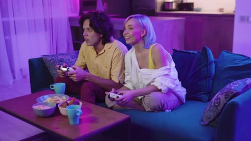 Couple Playing Video Games and Celebrating at Home