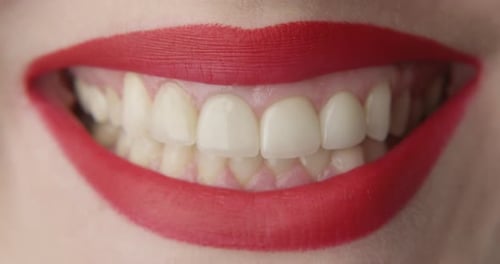 Close-up Of Woman's Mouth With Red Lipstick Smiling